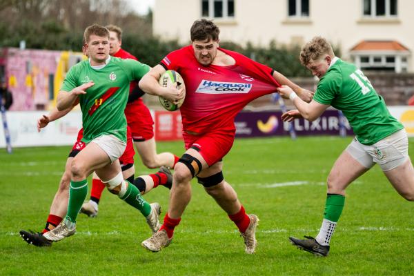 Rugby at St Peter. Jersey RFC (red) v London Irish Wild Geese (green).  George Willmott with ball                             Picture: ROB CURRIE