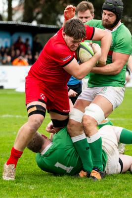 Rugby at St Peter. Jersey RFC (red) v London Irish Wild Geese (green).  George Willmott with ball                             Picture: ROB CURRIE