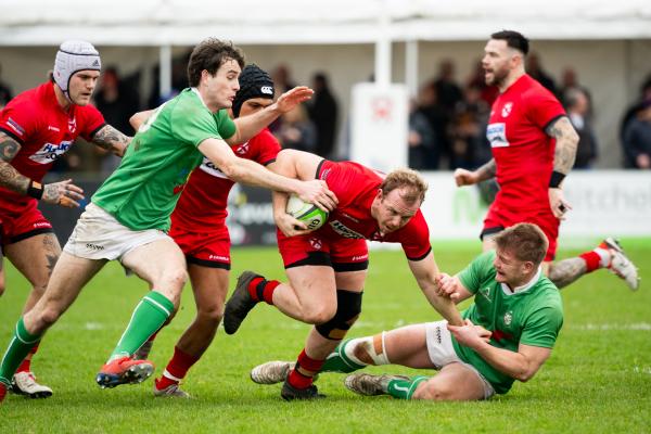 Rugby at St Peter. Jersey RFC (red) v London Irish Wild Geese (green). Nathan Rogers with ball                              Picture: ROB CURRIE