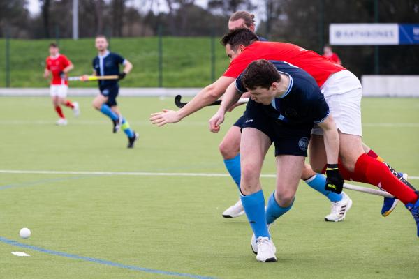 Hockey at Les Quennevais. Jersey (red) V Woking (blue).   Blue No 2 and Sam Dunstan                       Picture: ROB CURRIE