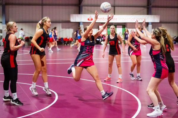 Netball at Les Ormes. St Lawrence A (purple) V St Clement A (black). Rena Nelson jumping for the ball                                 Picture: ROB CURRIE