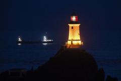Trimnity cargo ship rounding the point. Corbiere Lighthouse 150th anniversary ligh up Picture: DAVID FERGUSON