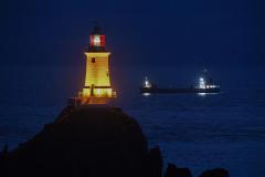 Trinity Cargo Ship rounding the point. Corbiere Lighthouse 150th anniversary ligh up Picture: DAVID FERGUSON