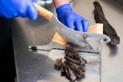 The Smokey Shed. Owner Neil Cotillard who makes Biltong and Smoked salmon.  Assistant Mick Rondel cutting Biltong prior to packaging                      Picture: ROB CURRIE