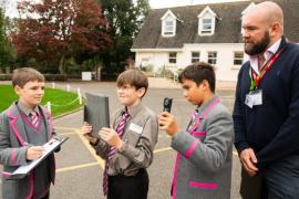 St Michael's school. 2024 Festival of Change,
 an inspiring week-long programme dedicated to sustainability, innovation, and education. Students use thermal imaging cameras to evaluate the school’s energy efficiency, fostering awareness around energy usage and climate impact. L>R John (12) holding clipboard and taking notes , Aurelian (11), holding iPad, Etienne (11), holding thermal imaging camera and Tom Wilson, product developer at Jersey Electricity, energy solutions department                          Picture: ROB CURRIE