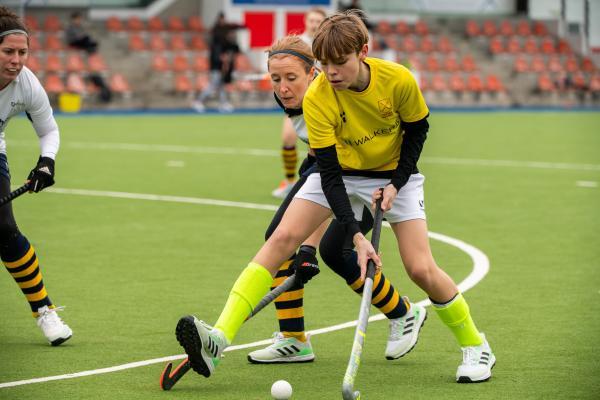 Hockey at Les Quennevais. Quakers (white) V Walkers Dragons (yellow). L>R Gemma Minty (nee Sutton) and Beau Johnstone-Scott                             Picture: ROB CURRIE