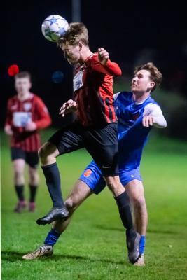Football at St Ouen. St Ouen (red/black) V St Peter (blue). L>R Joe Murphy and Harrison Moon                           Picture: ROB CURRIE