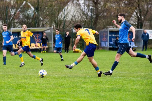Football at St Clement. St Clement (yellow) V Grouville (blue). Rai Dos Santos shoots at goal and scores (8 mins into first half)                  Picture: ROB CURRIE