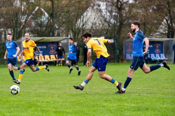 Football at St Clement. St Clement (yellow) V Grouville (blue). Rai Dos Santos shoots at goal and scores (8 mins into first half)                  Picture: ROB CURRIE