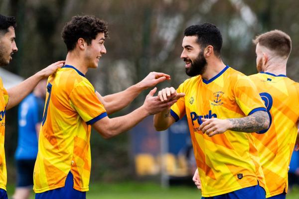 Football at St Clement. St Clement (yellow) V Grouville (blue). L>R Rai Dos Santos shoots at goal and scores (8 mins into first half) and celebrates with Ryan Campos                 Picture: ROB CURRIE