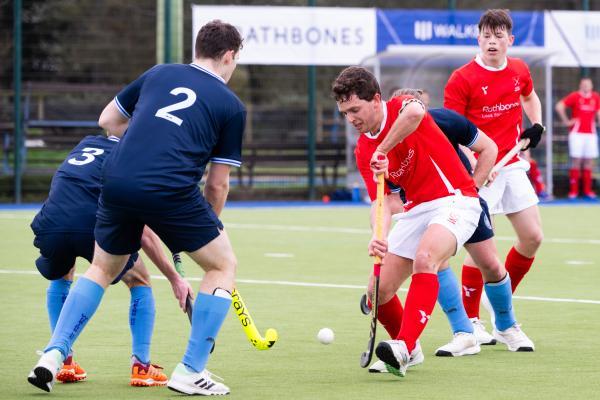 Hockey at Les Quennevais. Jersey (red) V Woking (blue). Tom Millar                                   Picture: ROB CURRIE