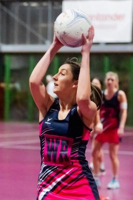 Netball at Les Ormes. St Lawrence A (purple) V St Clement A (black). Heather Rabet with ball                              Picture: ROB CURRIE
