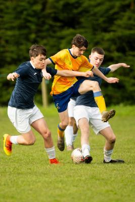 Football at Le Couvent. The Tregear Junior Memorial Trophy (U18): Rozel Rovers (blue) v St Clement (yellow). L>R Joe Racjan, Liam Brennan and Charlie Blair                    Picture: ROB CURRIE