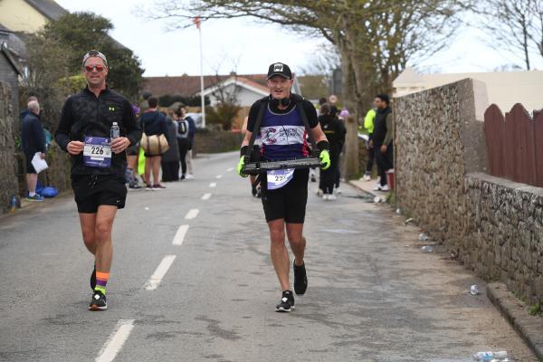 DJ going through the St Ouen Shop water station Hospice to Hospice Run Picture: DAVID FERGUSON