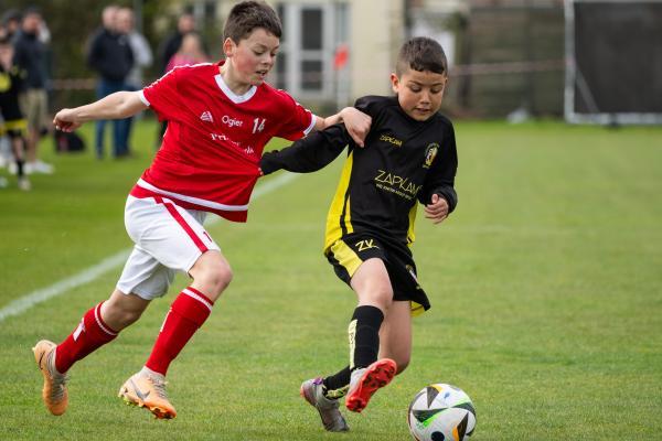 Football at FB Fields. Jersey Primary schools football festival. Jersey A (red) V Gloucester A (black). L>R Oscar Montford and La'Vai Ellis                            Picture: ROB CURRIE