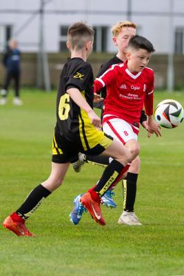 Football at FB Fields. Jersey Primary schools football festival. Jersey A (red) V Gloucester A (black). L>R Tyler Field and Luca Dodd                            Picture: ROB CURRIE