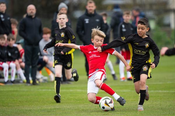 Football at FB Fields. Jersey Primary schools football festival. Jersey A (red) V Gloucester A (black). L>R Teijo Boletta and La'Vai Ellis                           Picture: ROB CURRIE
