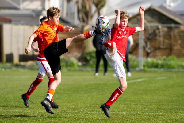 Football at FB Fields. Jersey Primary schools football festival. Jersey A (red) V Newbury B (orange). L>R Cory Oram and Mayson Woodley                            Picture: ROB CURRIE