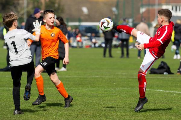 Football at FB Fields. Jersey Primary schools football festival. Jersey A (red) V Newbury B (orange). Fosco Farina-Richings shoots at goal                             Picture: ROB CURRIE