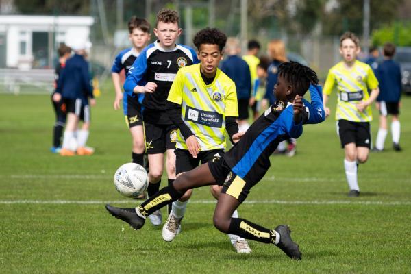 Football at FB Fields. Jersey Primary schools football festival. Glouscester B (black) V St Albans Yellows (yellow). L>R Rasmus Duncan and Daniel Matumba                            Picture: ROB CURRIE