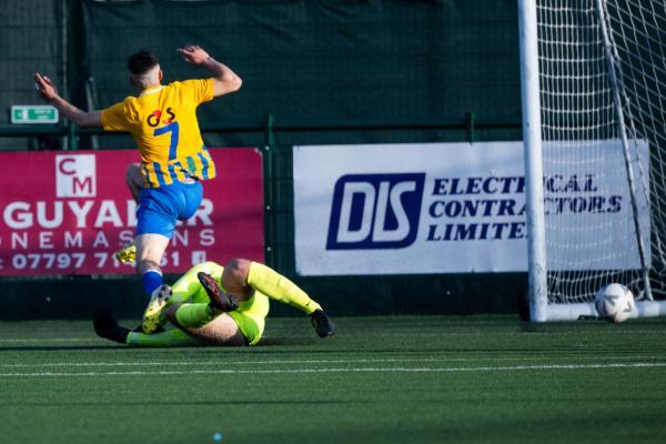 Football at Springfield. Jersey FA Cup final: Madeira (yellow) V St Brelade (red). L>R  Henrique Cristovao scores the first goal for Madeira beating goalkeeper Josh Jehan in about the third minute of the game                    Picture: ROB CURRIE