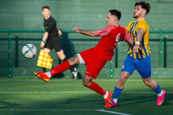 Football at Springfield. Jersey FA Cup final: Madeira (yellow) V St Brelade (red). L>R Kieran Lester has a shot at goal and Nelson Vieira                     Picture: ROB CURRIE
