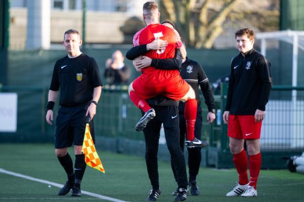 Football at Springfield. Jersey FA Cup final: Madeira (yellow) V St Brelade (red). Kris McAdam (middle) celebrates scoring the first goal for St Brelade                      Picture: ROB CURRIE