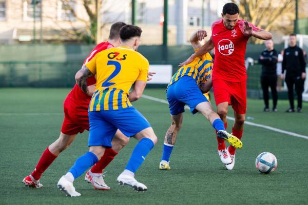 Football at Springfield. Jersey FA Cup final: Madeira (yellow) V St Brelade (red). L>R Henrique Cristovao and Mikey Weir                       Picture: ROB CURRIE
