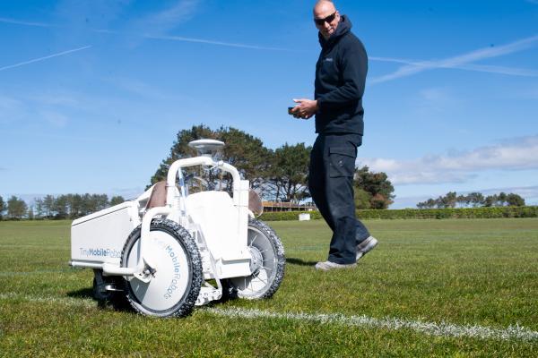 Groundsman Andrew McCarter using a remote line painting robot to go over the football pitch lines at Les Quennevais. The GPS controlled 'Tiny Robot' has been in use for about a year and can mark out an unmarked pitch in around twenty minutes as against half a day by hand Picture: JON GUEGAN