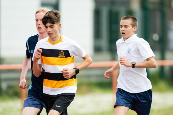 Athletics at the track at FB Fields. Schools athletics cup - boys year 7/8 & 9/10. 1,500m race. L>R Sam Oldham (15) of Les Quennevais won, Zane Simpson (14) of Victoria College came second and Danny Wood (15) of Hautlieu came third in this race this race                         Picture: ROB CURRIE