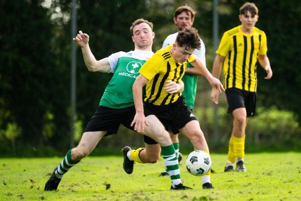 Football at IJB Field, St Saviour. Sporting Academics (green) V St Pauls (yellow). L>R  Phil Quinn and Ewan Brodie                     Picture: ROB CURRIE