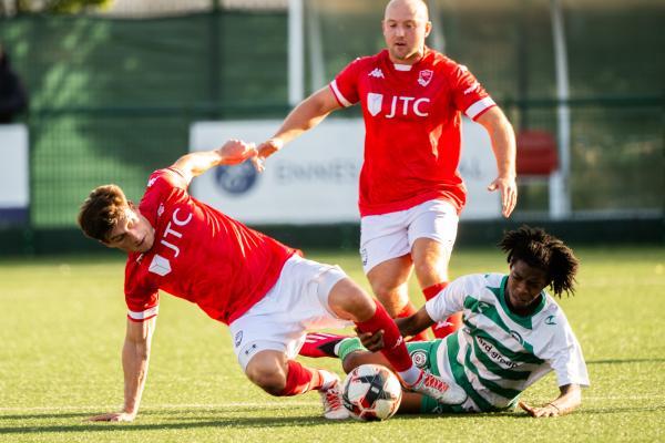 Football at Springfield. Chipstead (green) V Jersey Bulls (red). L>R Jonny Le Quesne and  Cameron Jorrell Lewis-Brown                       Picture: ROB CURRIE