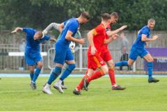 Island Games Guernsey 2023 IG 2023. Footes Lane athletics track. Football final. Jersey (blue) V Ynys Mon (red). Goalkeeper Carl Jones had his hands on more than the ball throught the game. Man handling Karl Hinds here                               Picture: ROB CURRIE